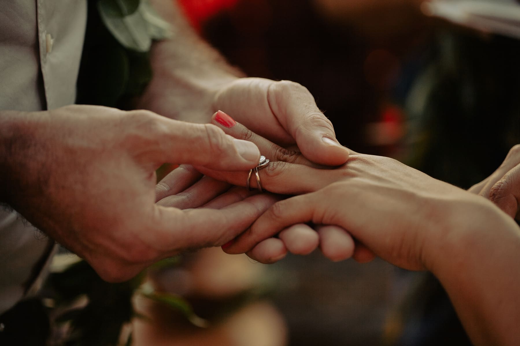 Close-up of hands exchanging a wedding ring