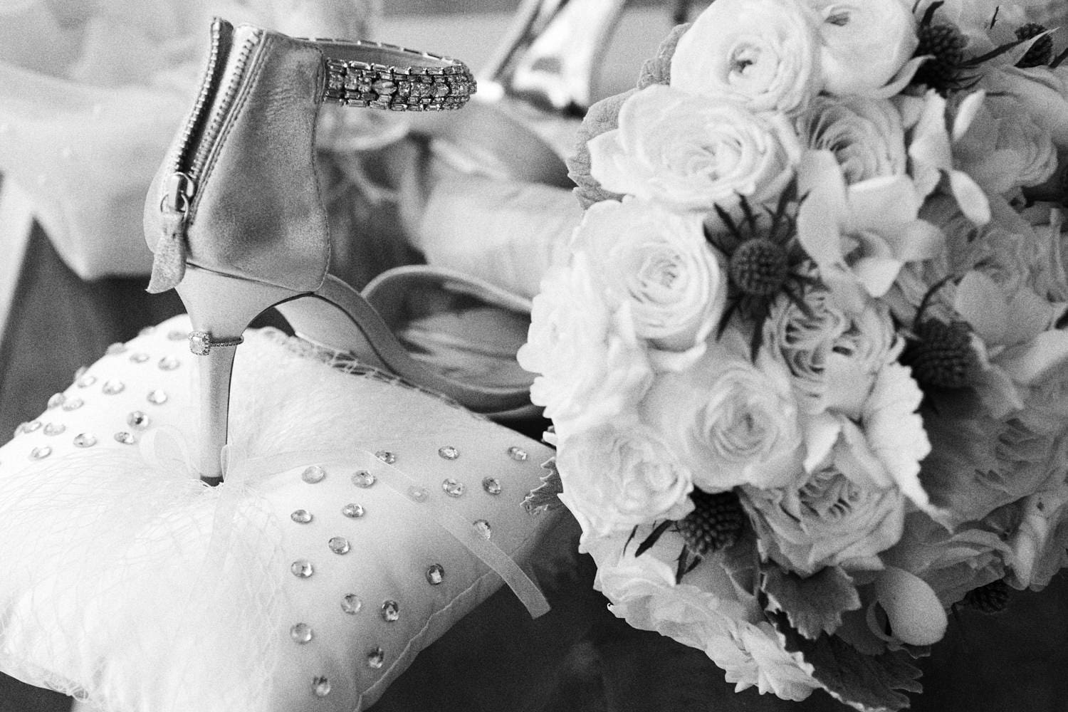 Wedding shoe resting on a pillow beside a bouquet of roses, wedding in Miami