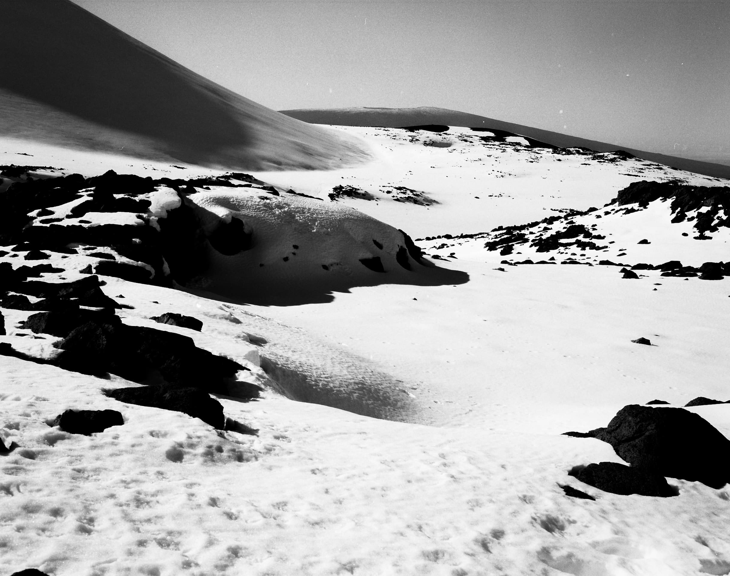 Black and white photograph of snow on the summit of Maunakea