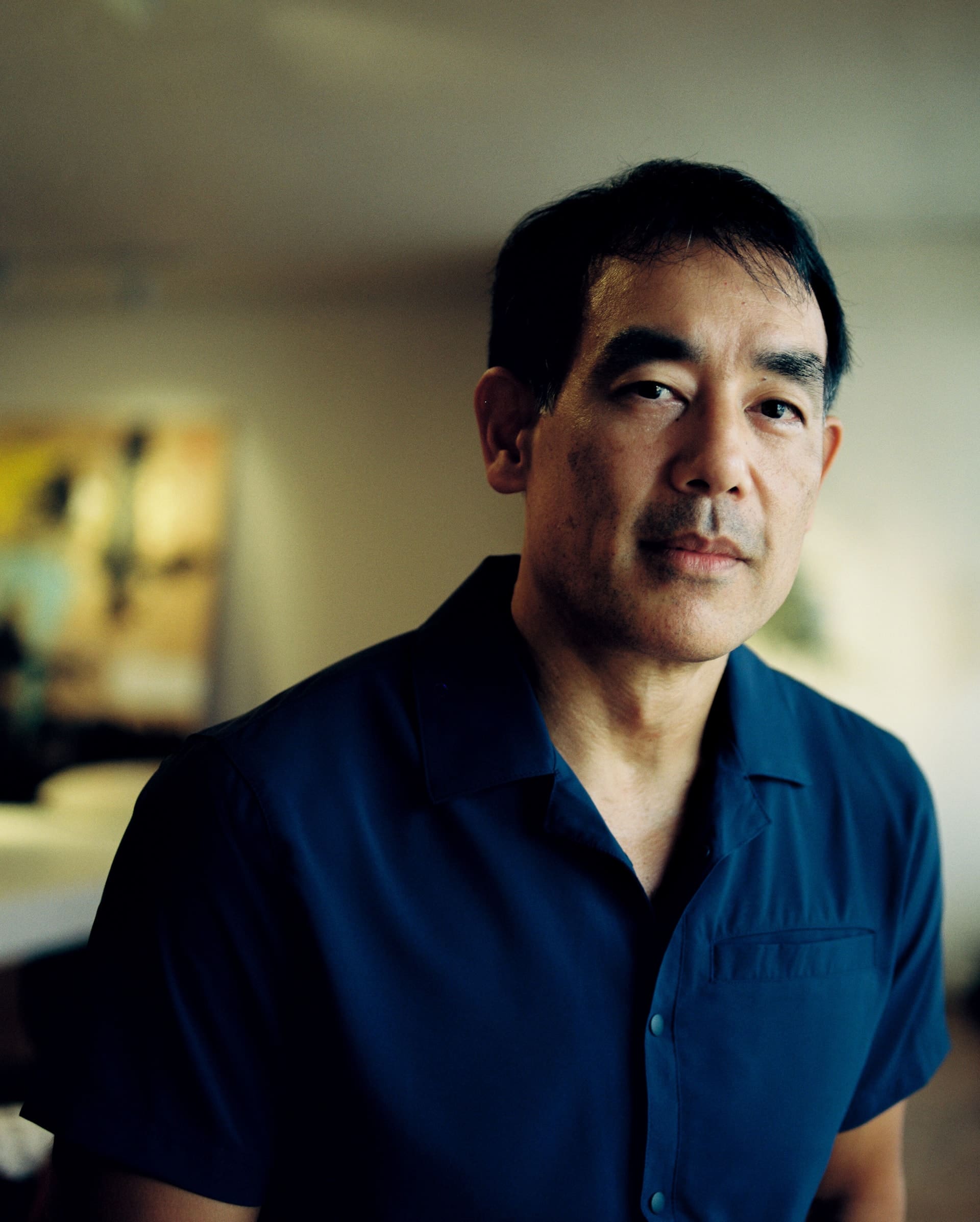 Portrait of a man in a navy shirt in an office