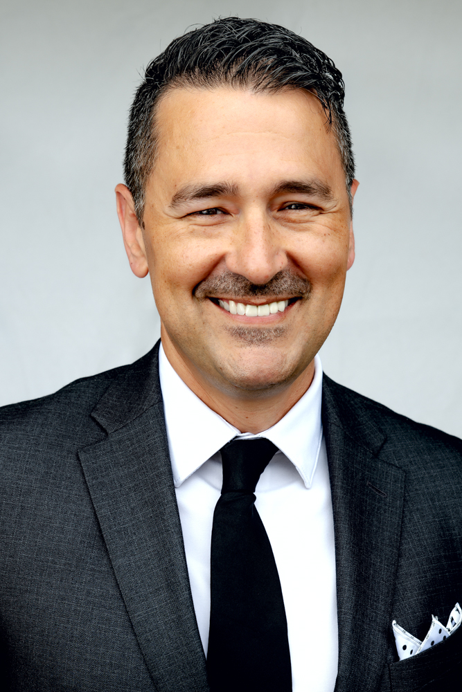 Professional headshot by photographer in Hilo Hawaii blending flash with natural light for Big Island business portraits